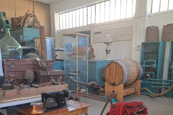 Collection of antique items including a sewing machine, barrel, and old machinery